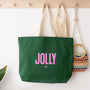 Green tote bag with 'Jolly' text, beige bag, and colorful woven bag on a white surface.