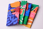 Set of colorful folded fabric swatches on a light background