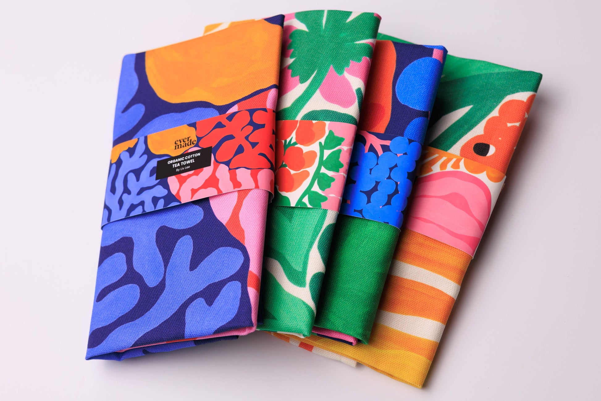 Set of colorful folded fabric swatches on a light background