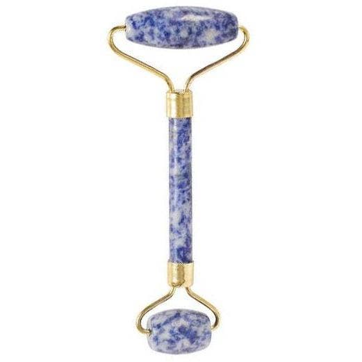 Facial roller with blue stone handle and gold accents on a white background