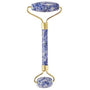 Facial roller with blue stone handle and gold accents on a white background