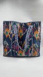 Colorful handbag with intricate patterns on a white background
