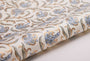 Roll of fabric with intricate paisley pattern on a white background