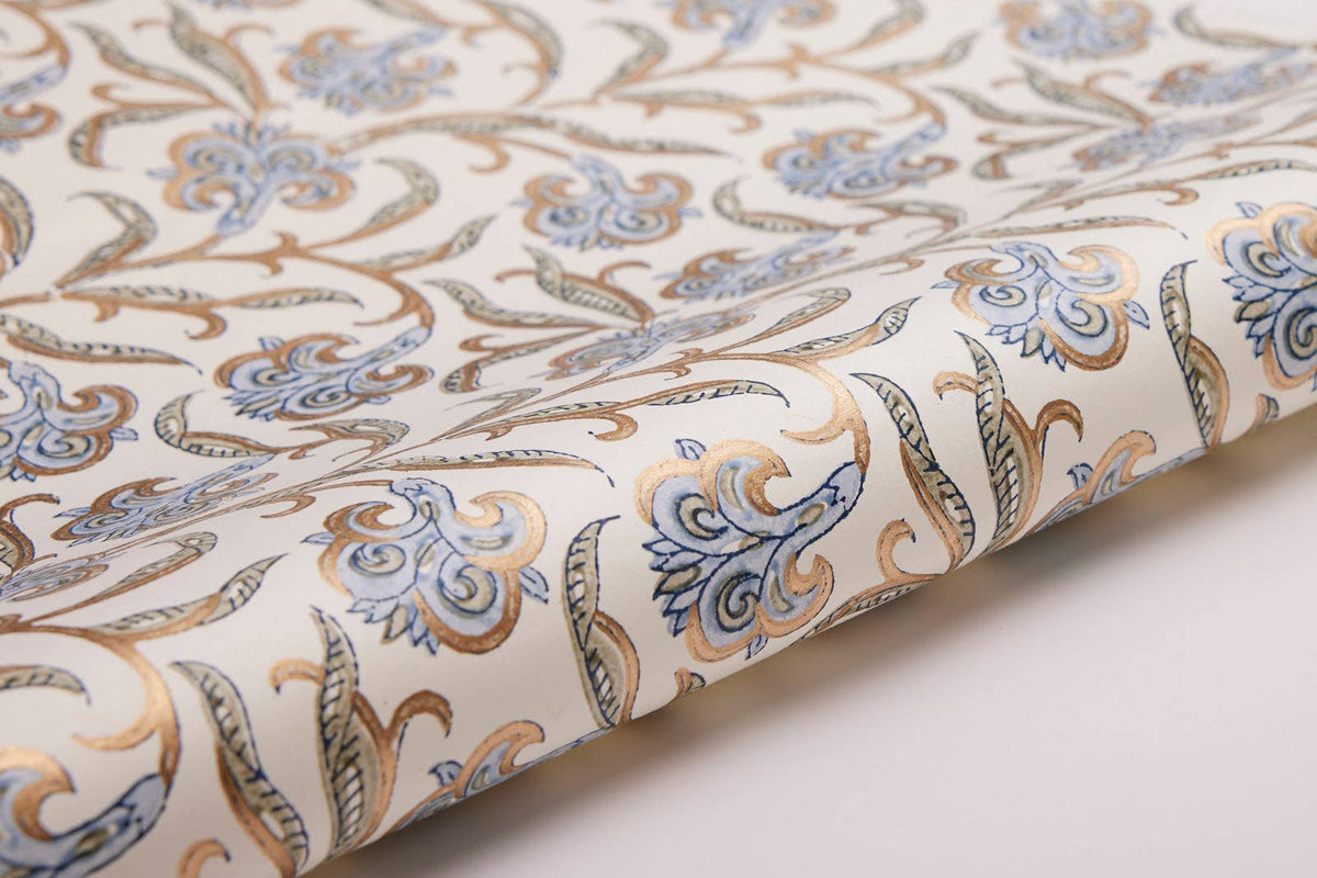 Roll of fabric with intricate paisley pattern on a white background