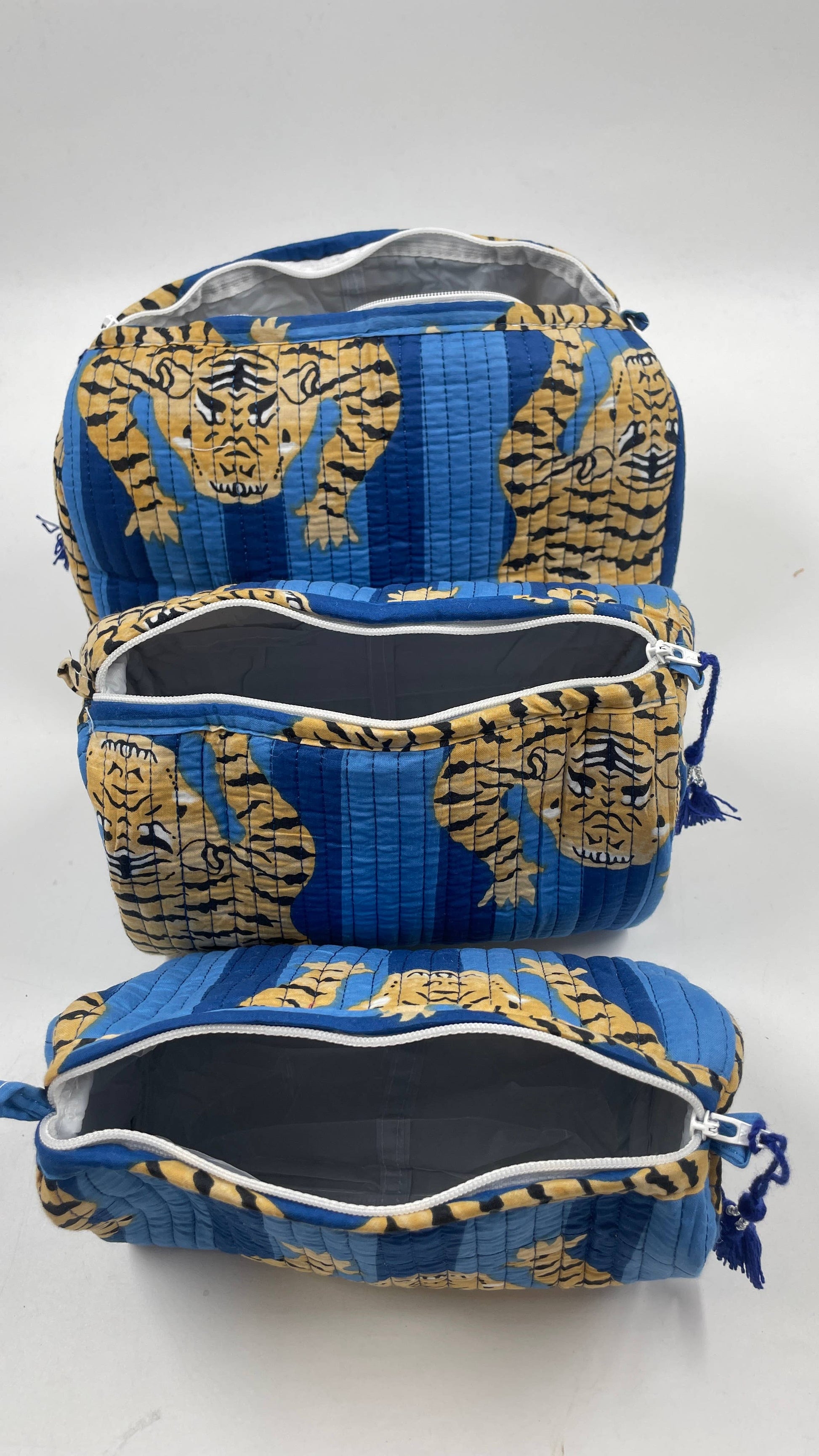 Blue and gold tiger-patterned bag on a white background