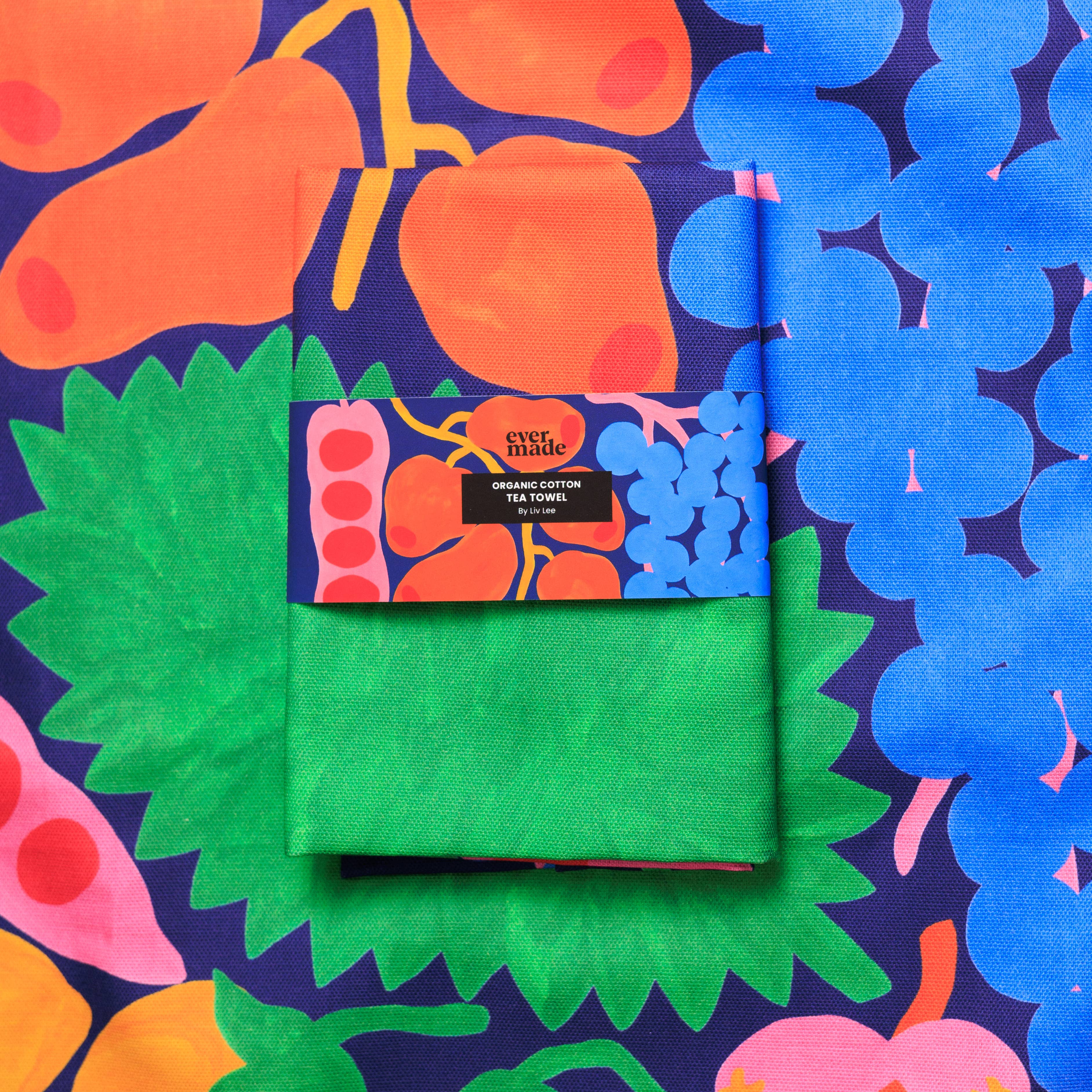 Green tea towel with colorful packaging on a patterned background