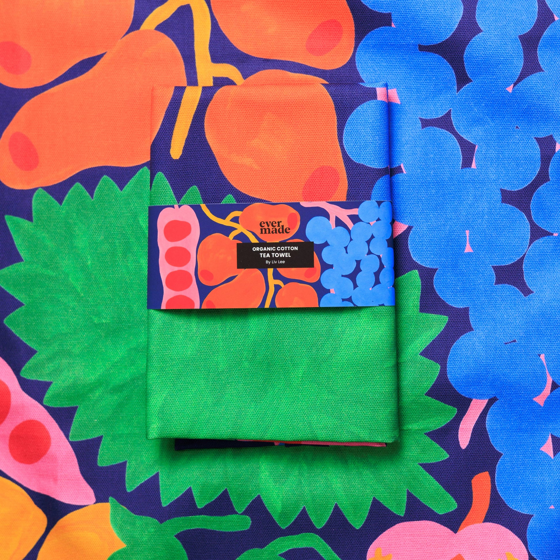 Green tea towel with colorful packaging on a patterned background