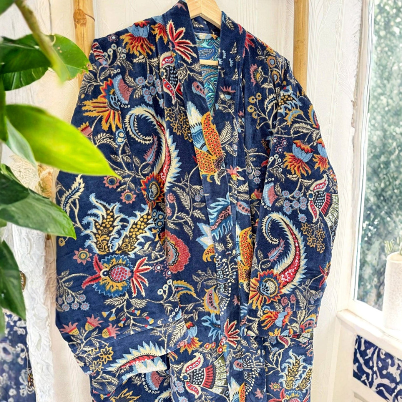 Colorful floral-patterned garment hanging on a rack with a window in the background
