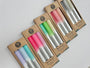 Set of colorful markers in cardboard packaging on a light background