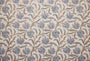 Patterned fabric with blue and brown floral design on a beige background