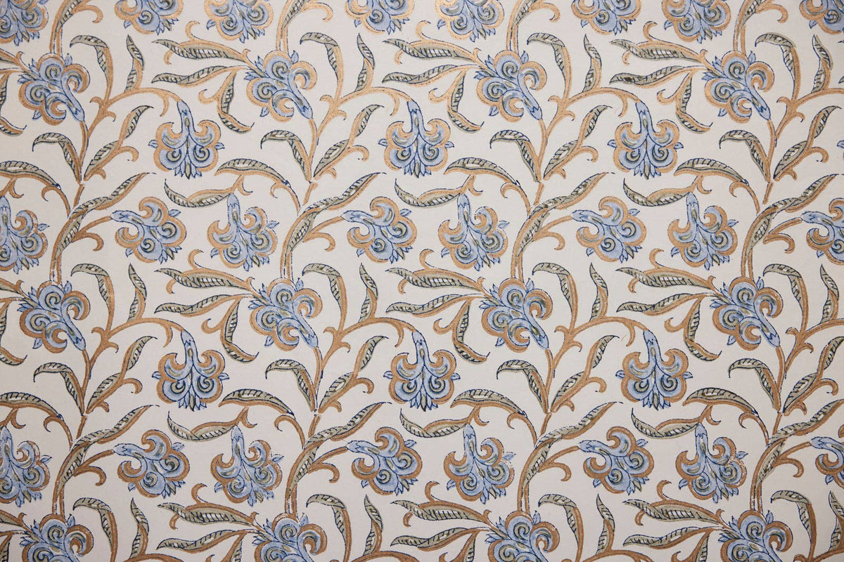 Patterned fabric with blue and brown floral design on a beige background