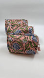 Two pink floral-patterned bags stacked on a white background