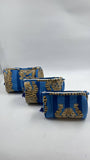 Two blue and gold patterned pouches on a white background