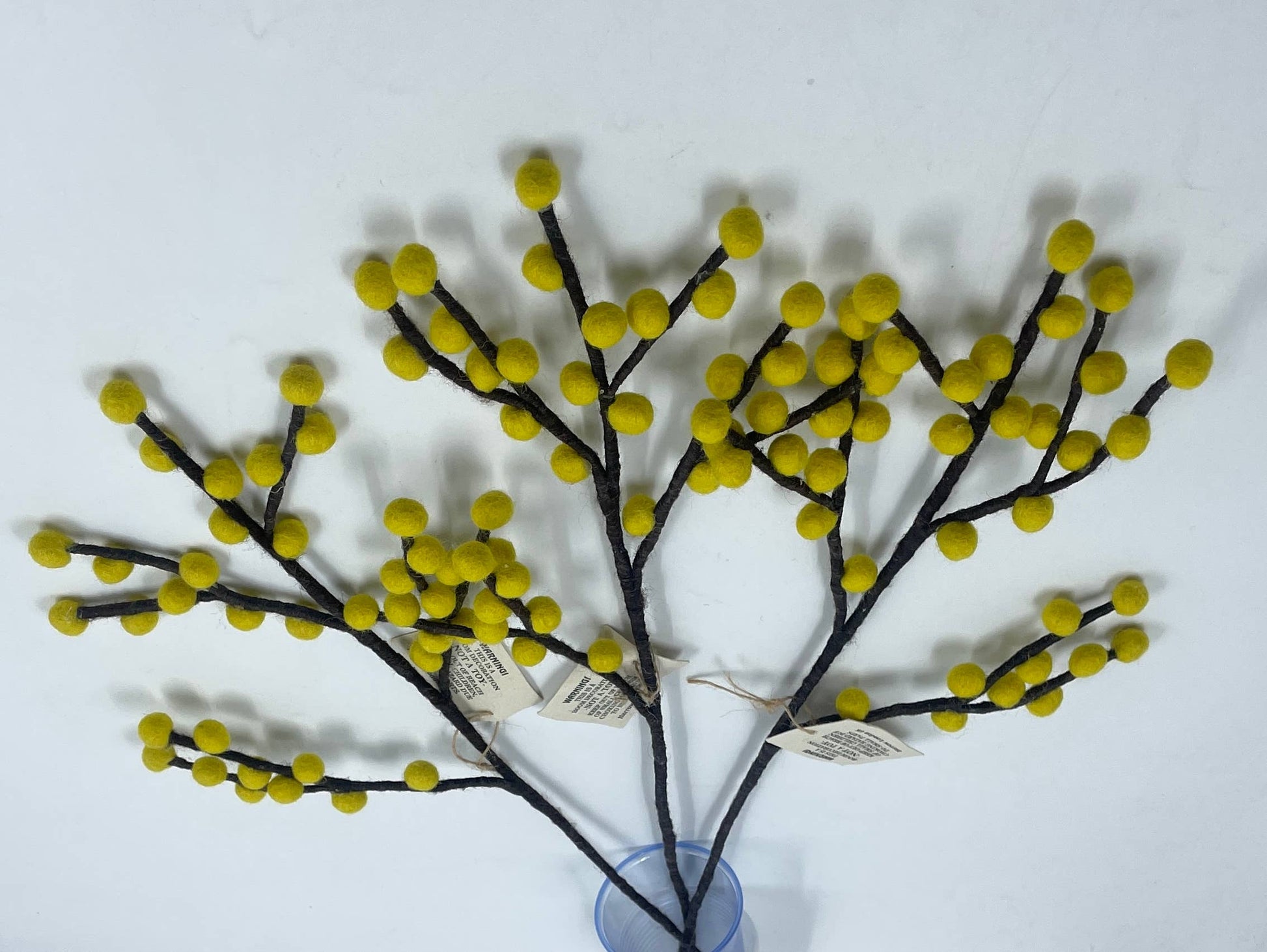 Decorative branch with yellow berries on a white background