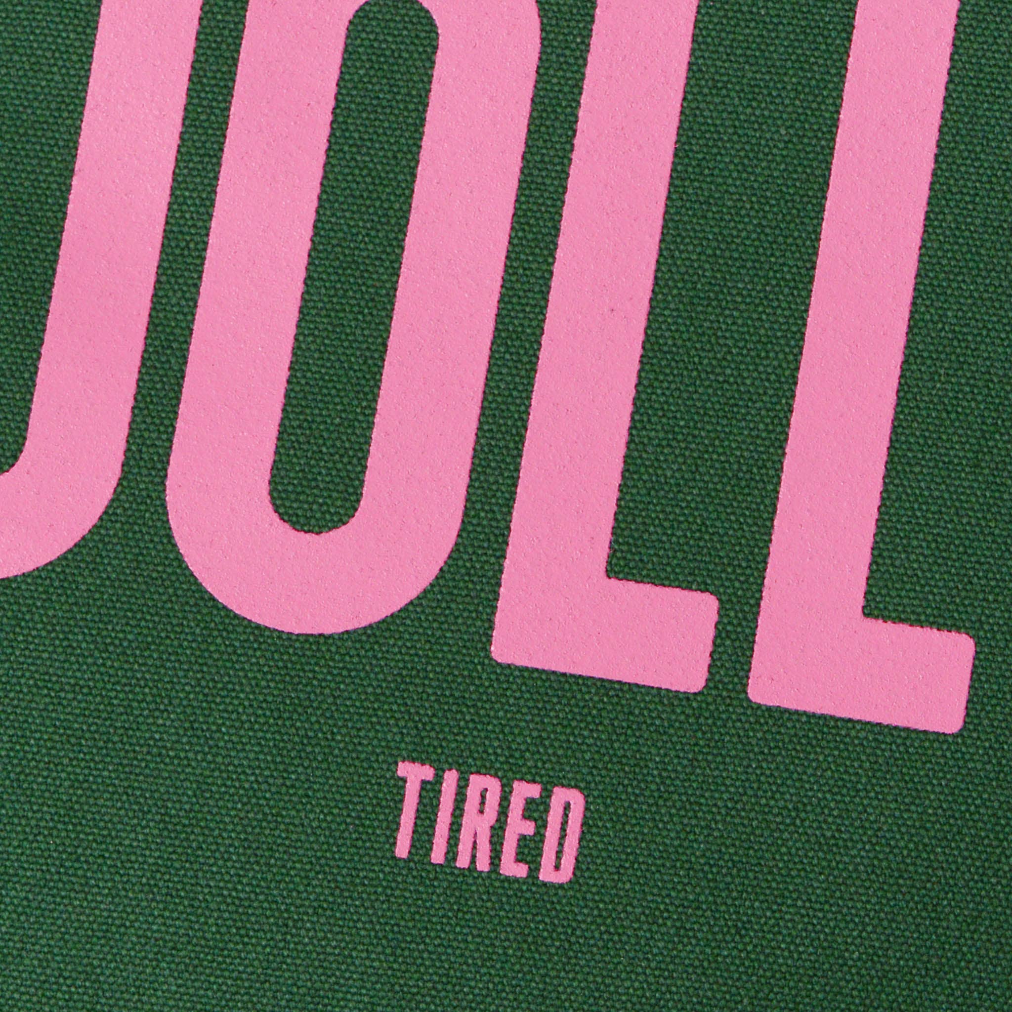 Close-up of a green and pink text design with 'UOLL' and 'TIRED'.