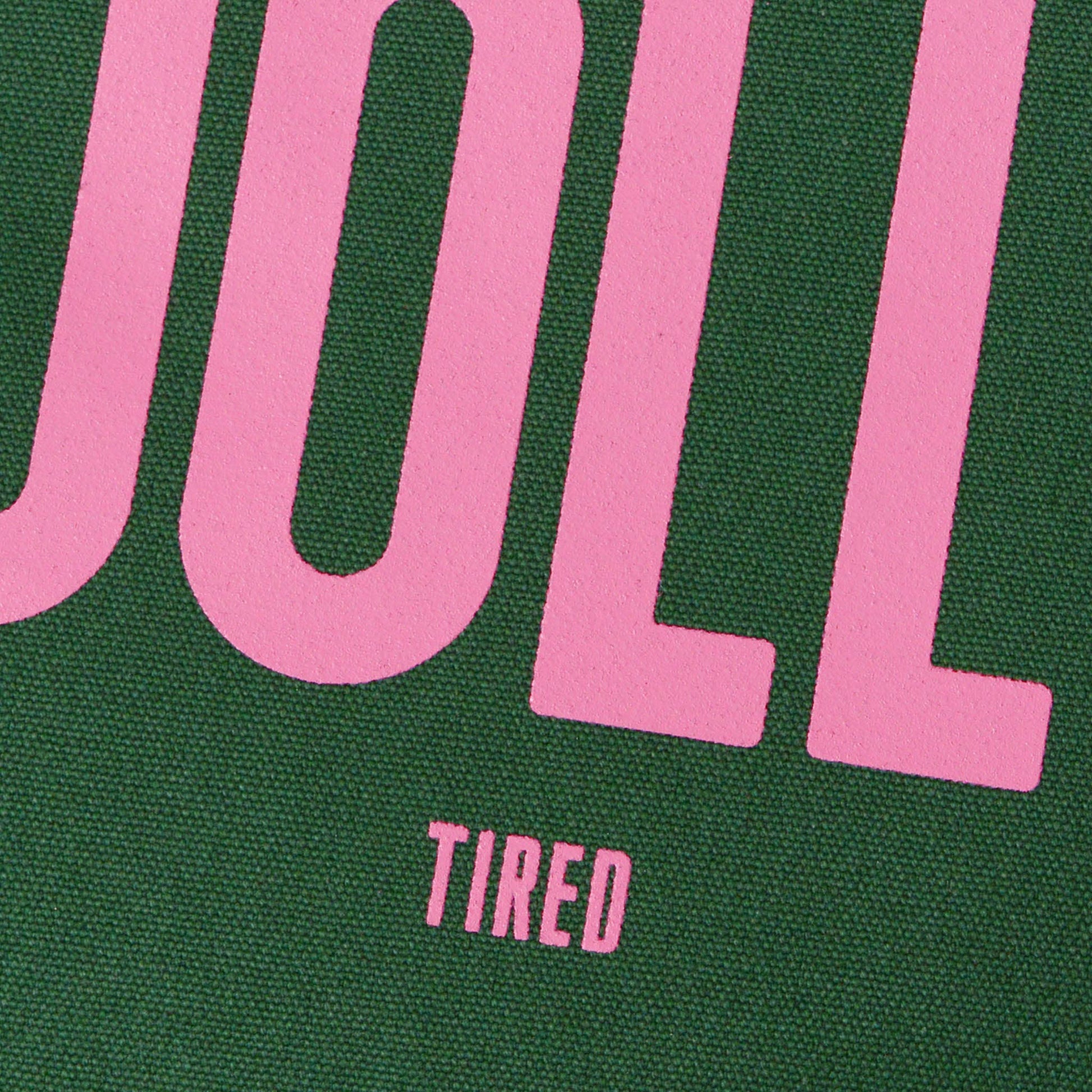 Close-up of a green and pink text design with 'UOLL' and 'TIRED'.