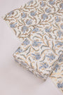 Roll of floral patterned fabric on a light background