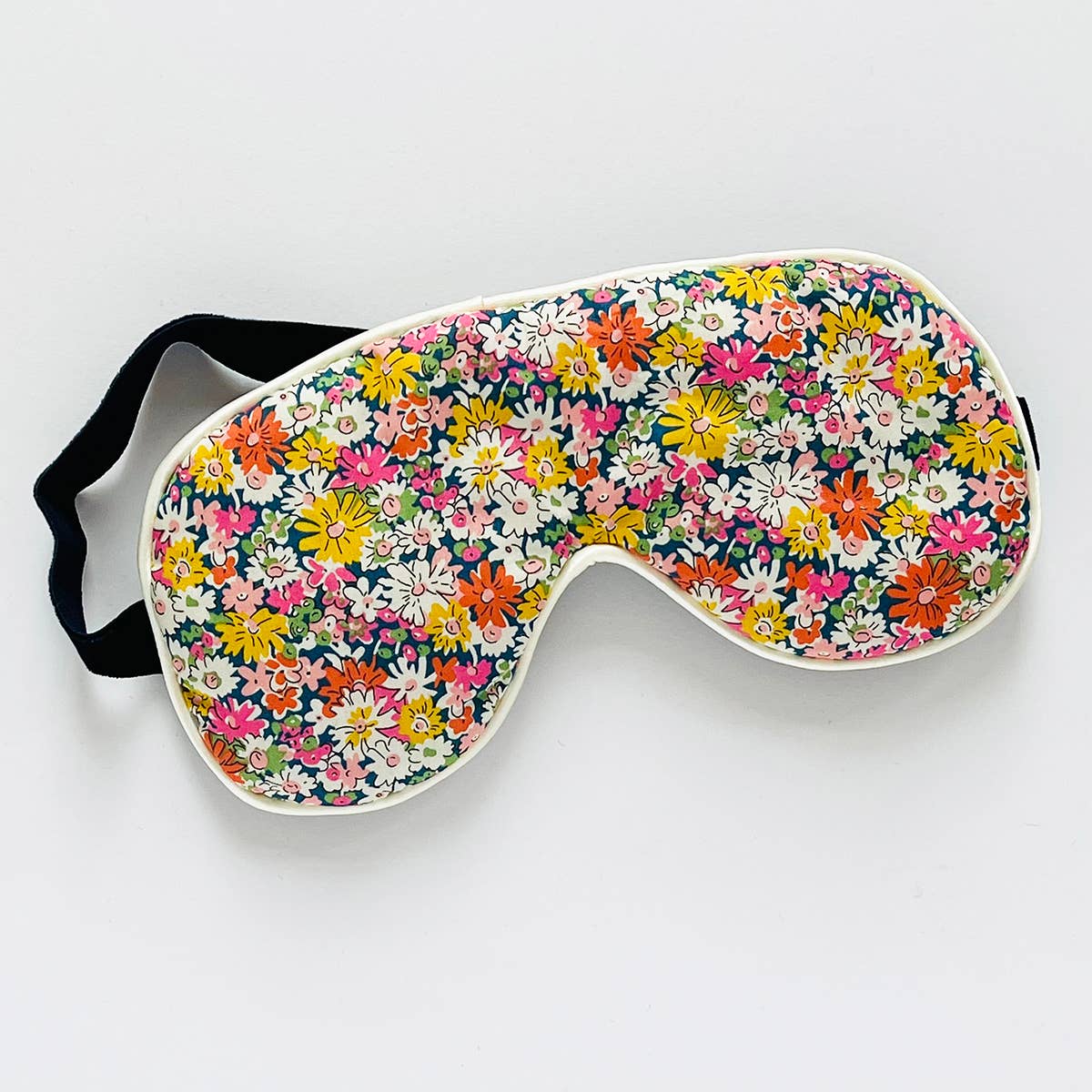 Floral patterned eye mask on a white background