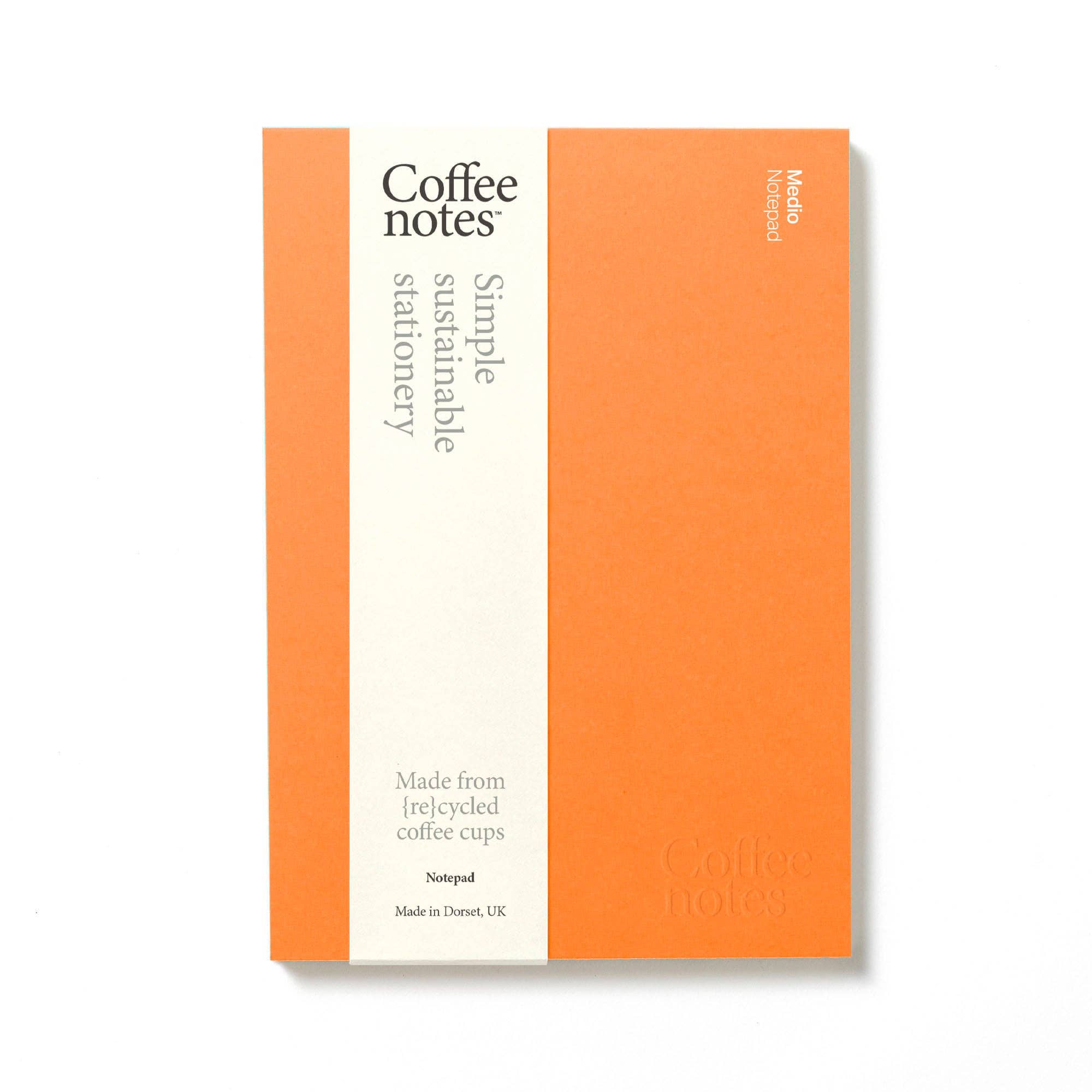 Notebook with orange cover and white text on a white background
