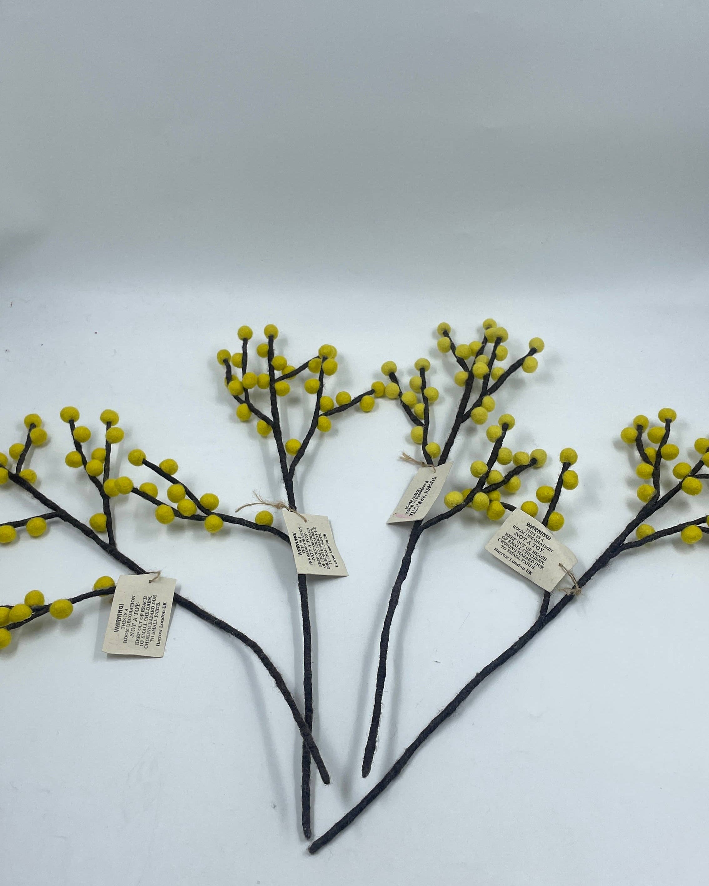 Decorative branches with small yellow flowers on a white background