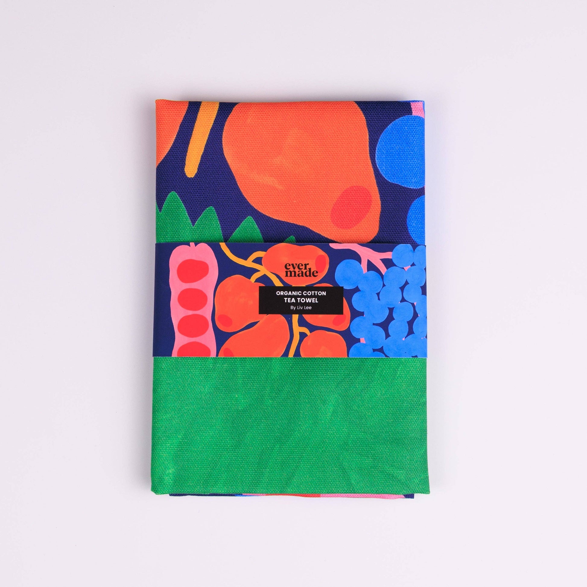 Colorful tea towel with vegetable pattern on a white background