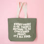 Green tote bag with motivational quote on a pink background