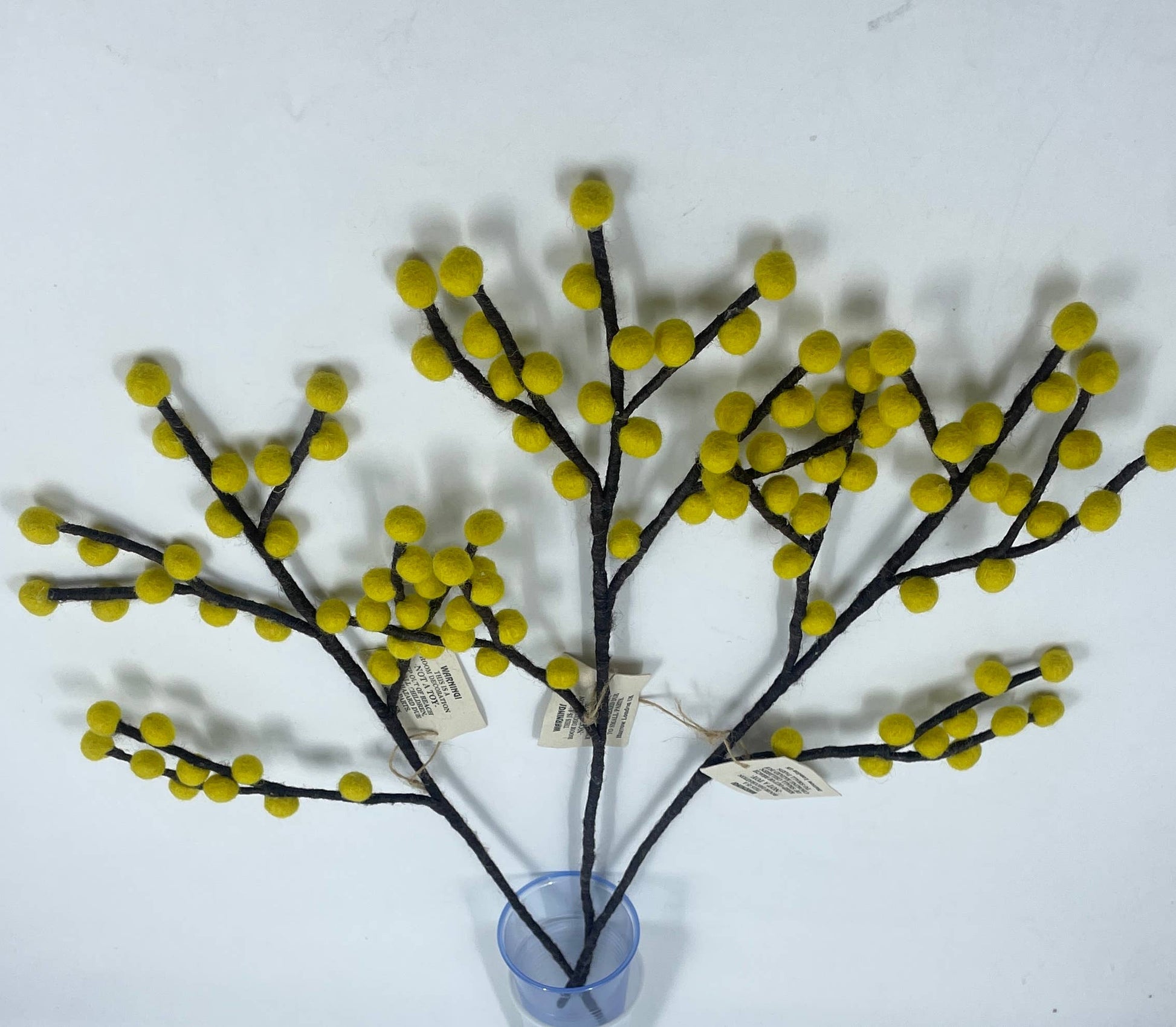 Decorative branch with yellow berries on a white background