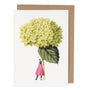 Greeting card with illustration of a person holding a large green flower, on a white background with a brown envelope.