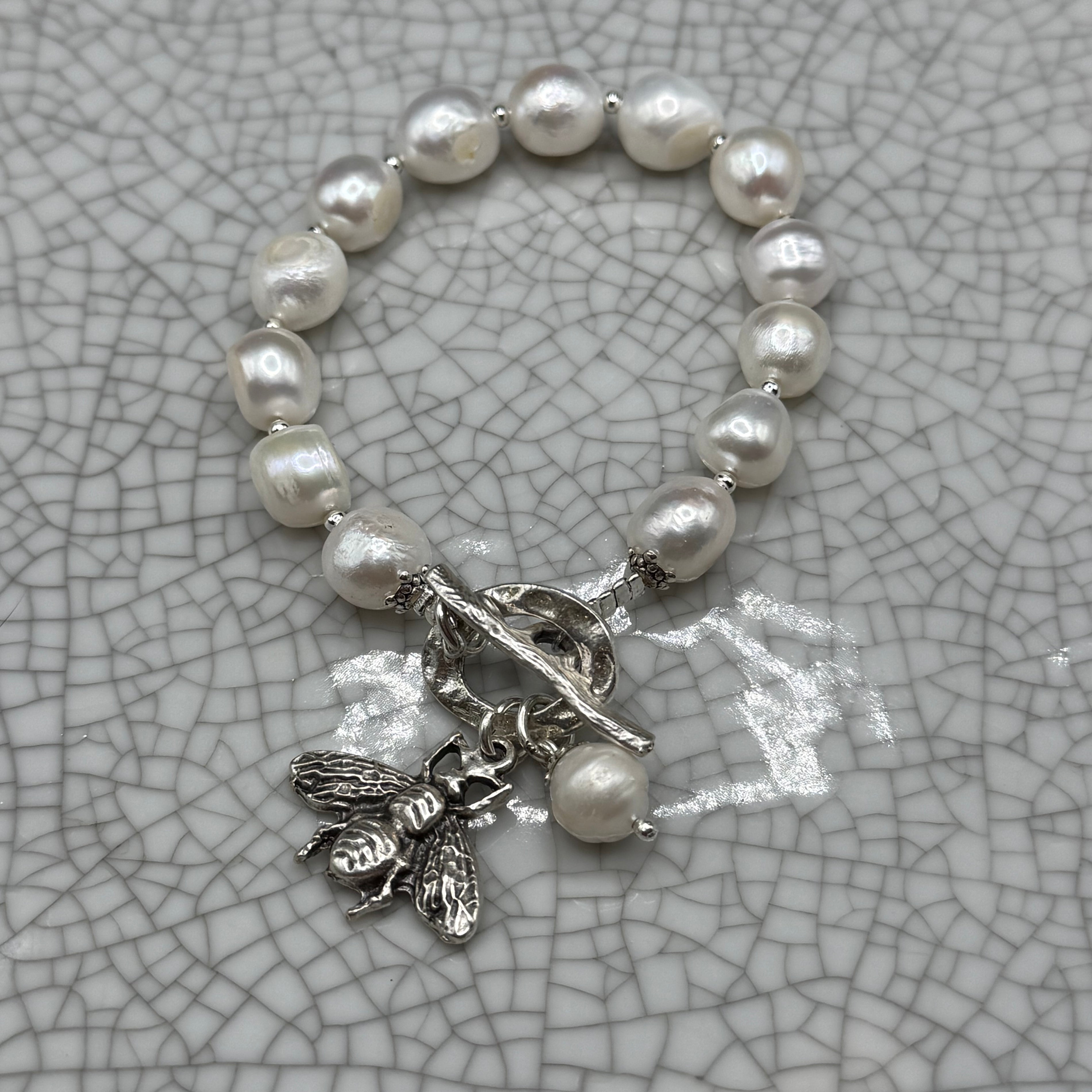 Freshwater pearl bracelet with silver bee charm, pearl drop and T-bar clasp, handmade in Bristol