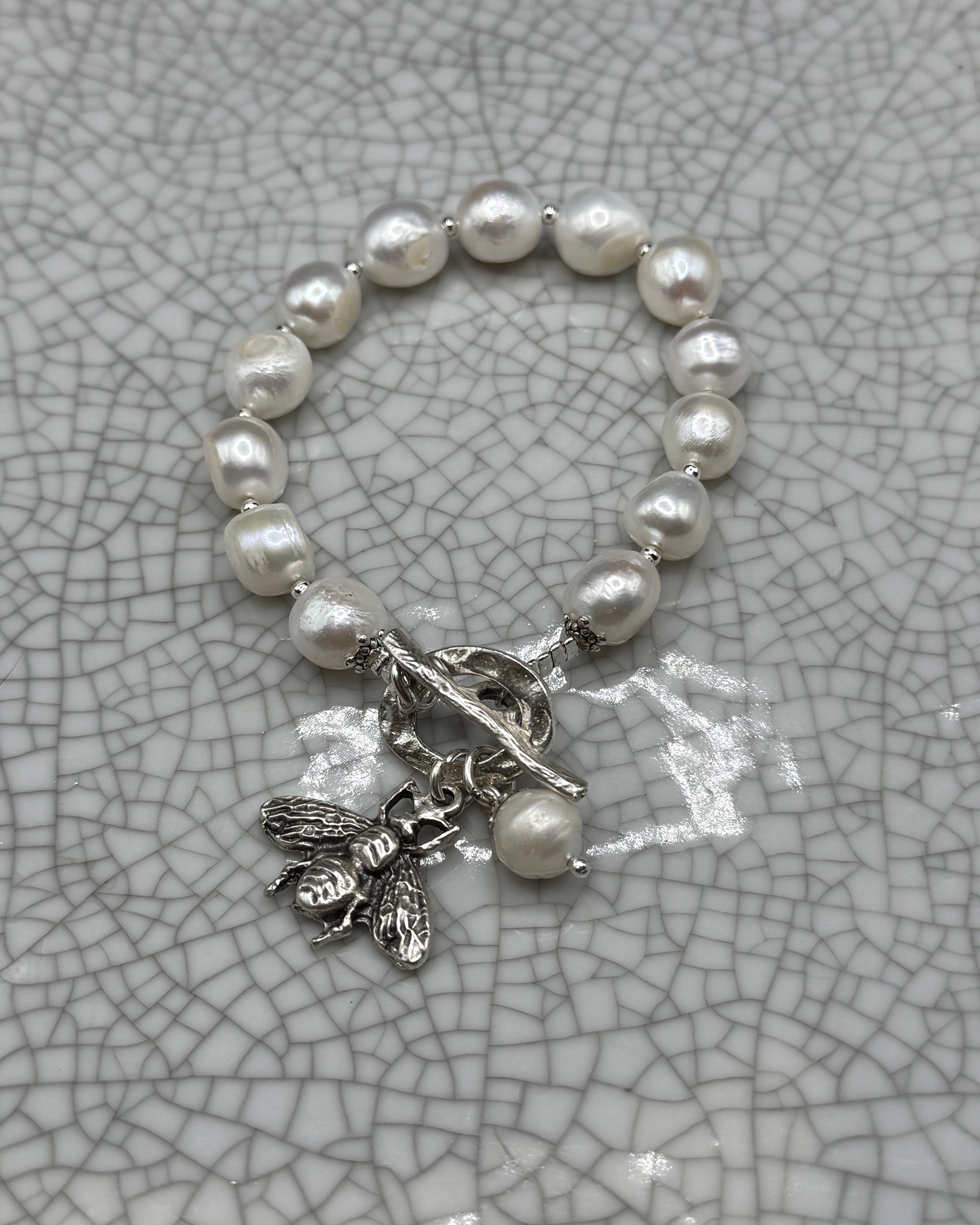 Freshwater pearl bracelet with silver bee charm, pearl drop and T-bar clasp, handmade in Bristol