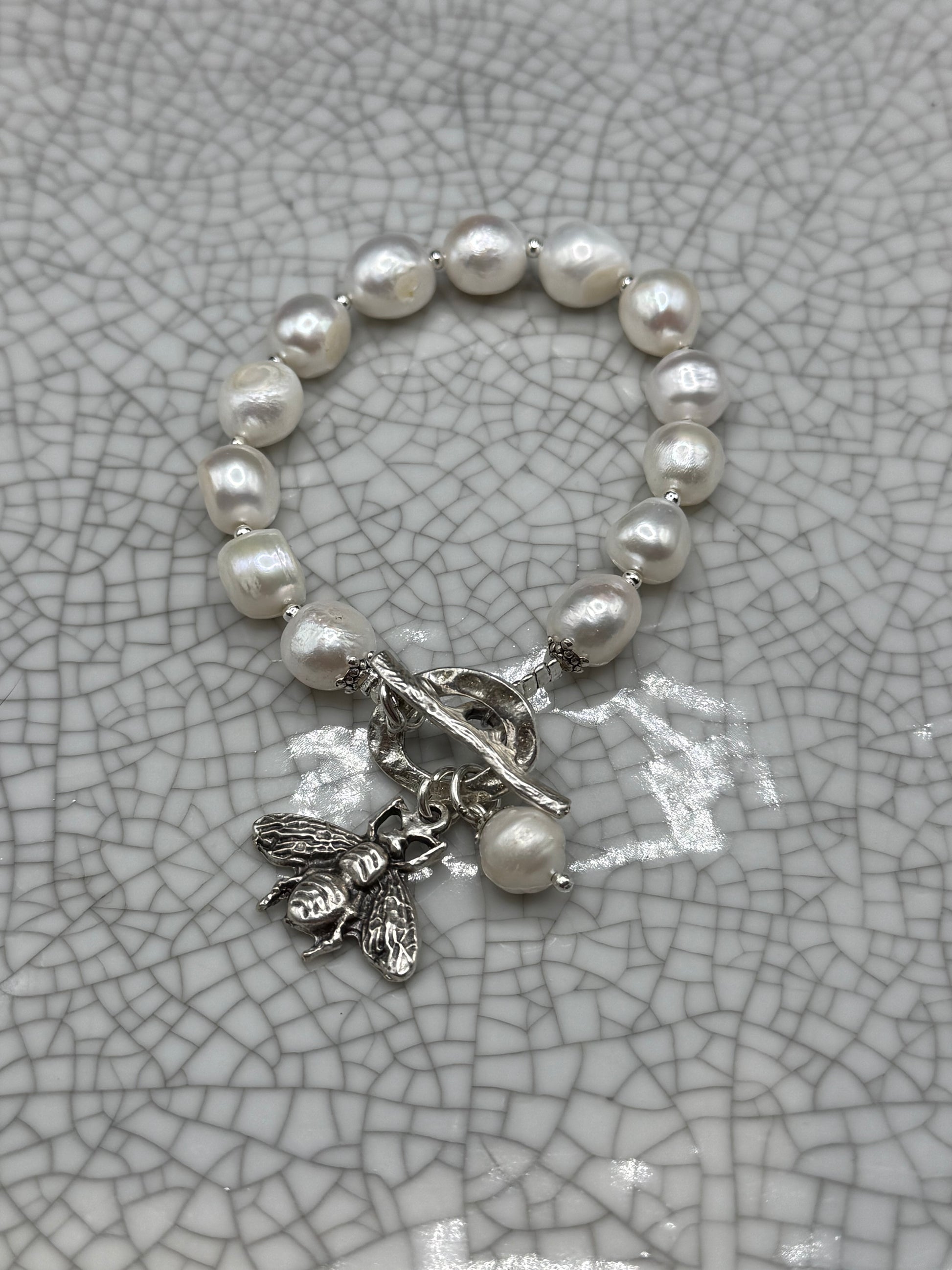 Freshwater pearl bracelet with silver bee charm, pearl drop and T-bar clasp, handmade in Bristol