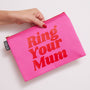 Pink pouch with 'Ring Your Mum' text held by a hand on a light background