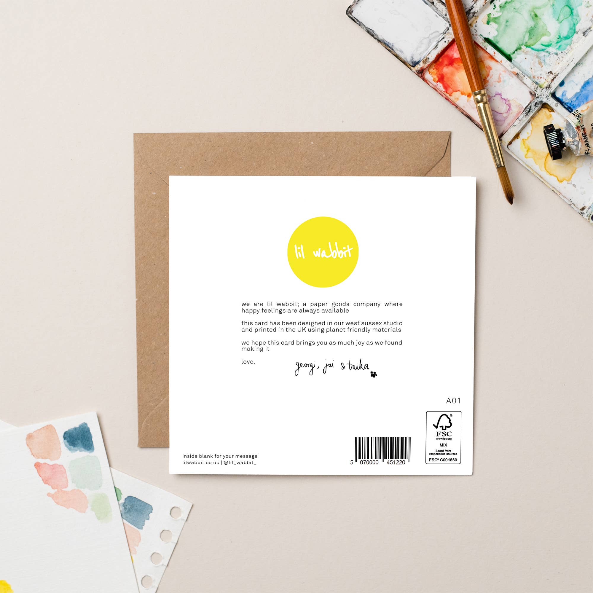 Back of a card with a yellow dot logo and text on a beige background