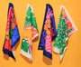 Four colorful scarves with floral and abstract patterns on a yellow background