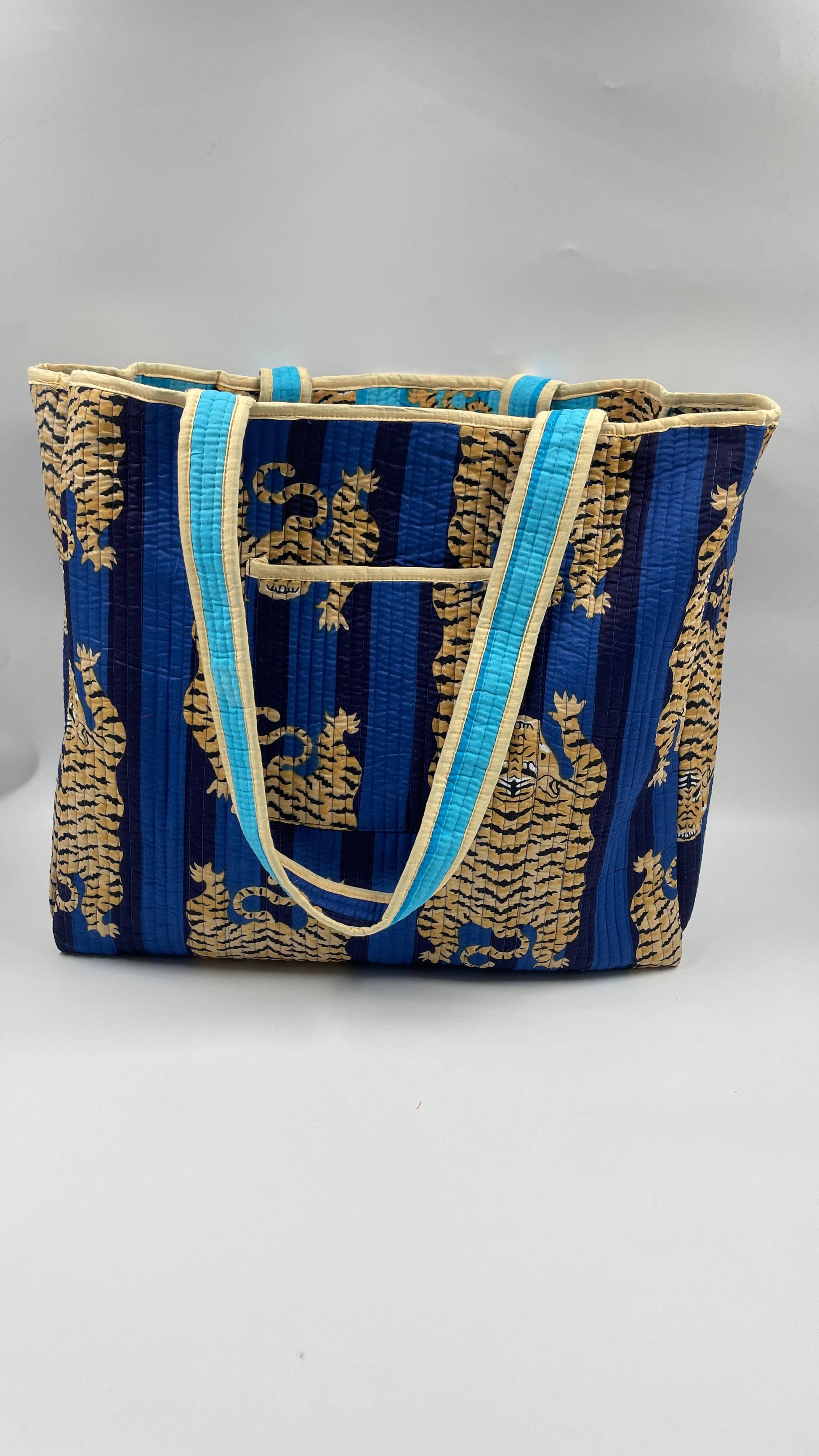 Blue and gold patterned tote bag on a white background
