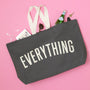 Gray tote bag with 'EVERYTHING' text on a pink background