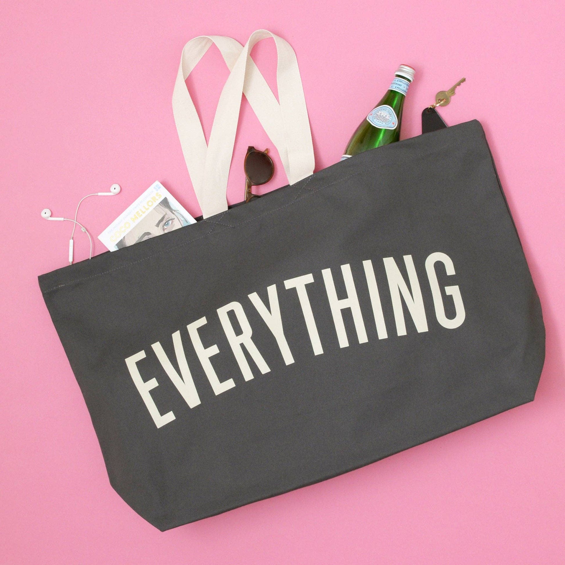 Gray tote bag with 'EVERYTHING' text on a pink background