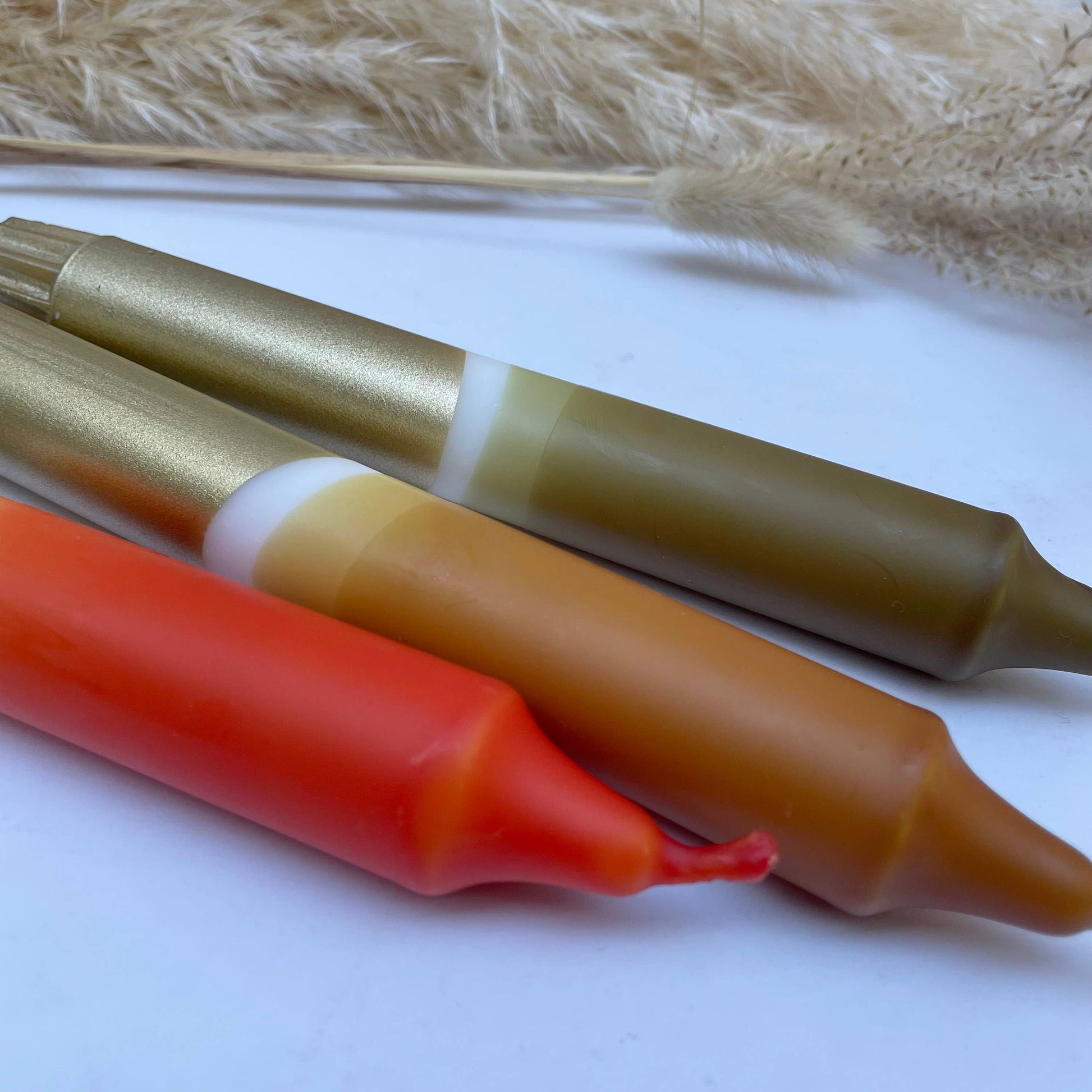 Three colorful hot dog buns on a white surface with a natural background