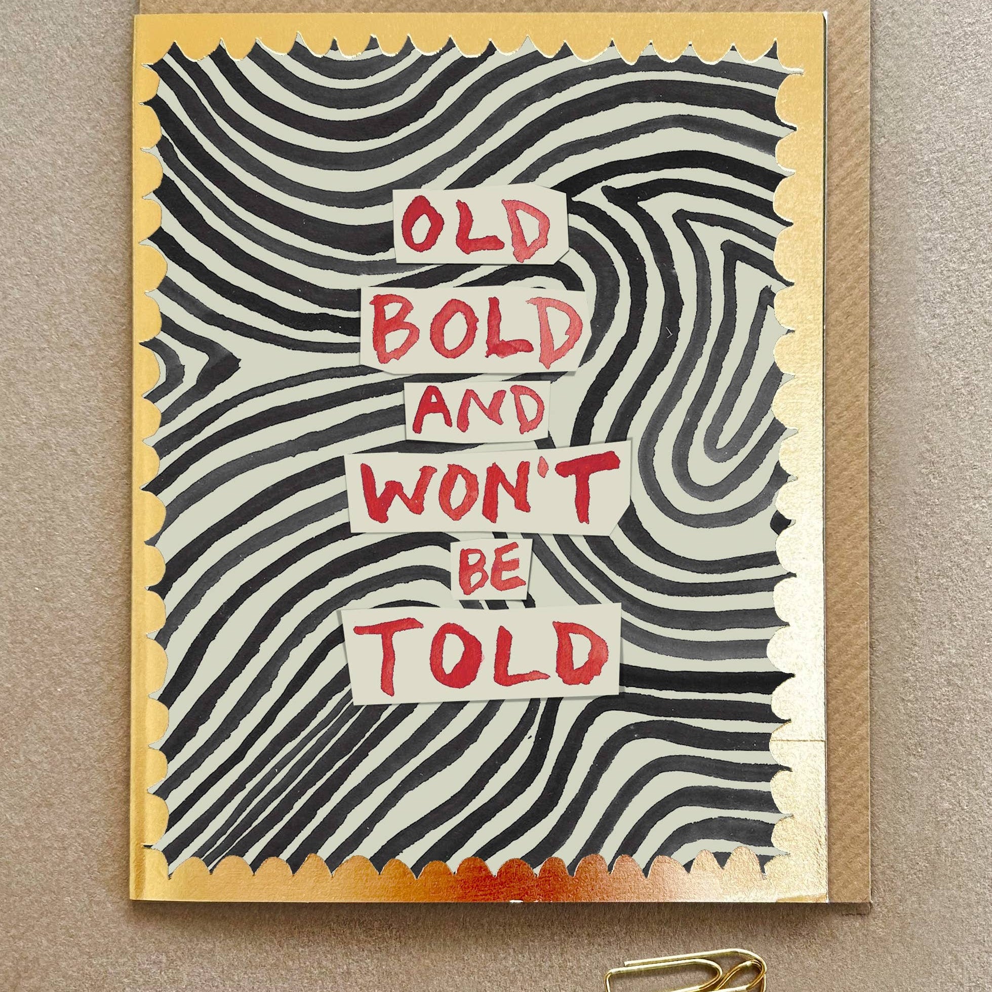 Greeting card with wavy pattern and text 'Old Bold and Won't Be Told' on a beige background