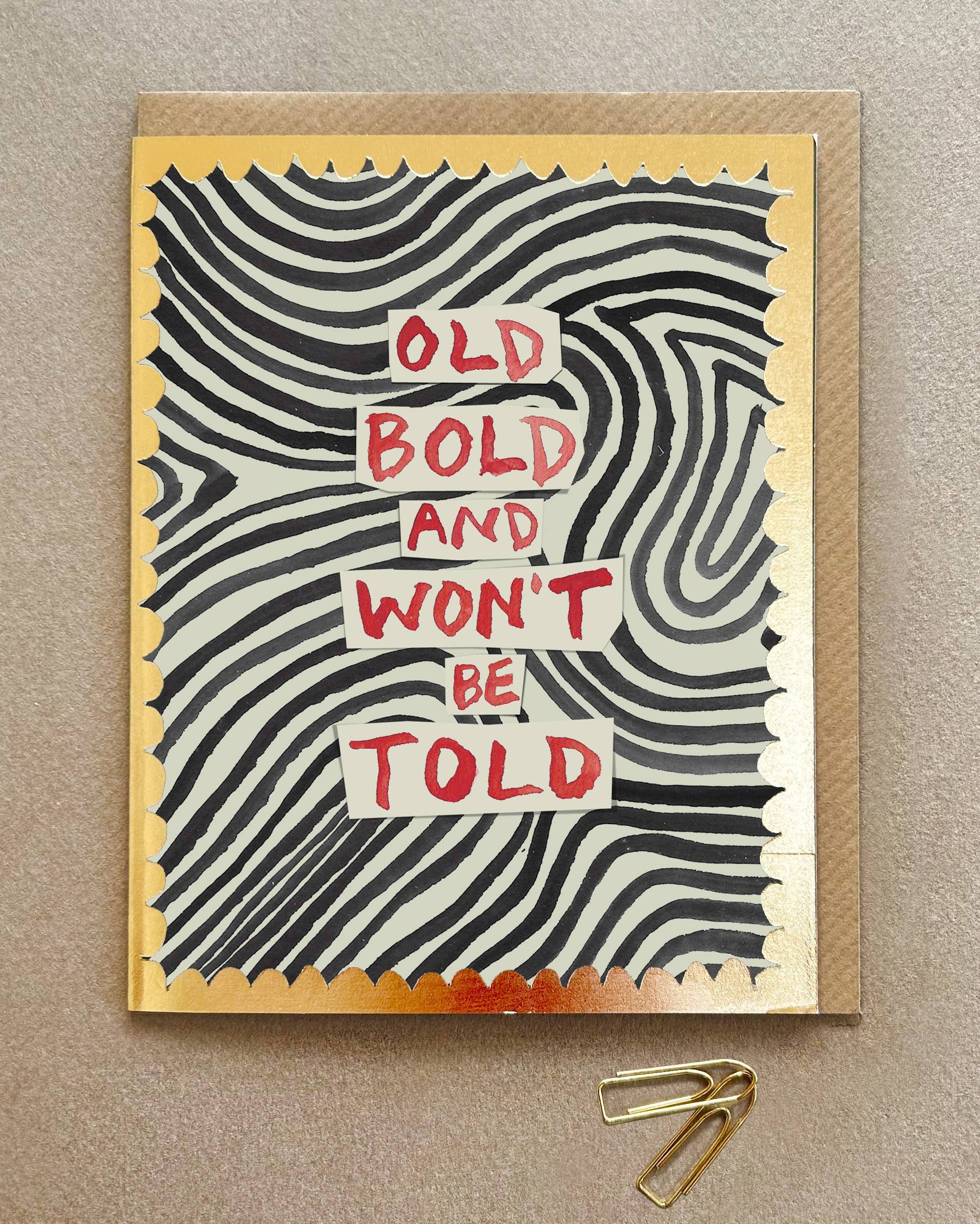 Greeting card with wavy pattern and text 'Old Bold and Won't Be Told' on a beige background