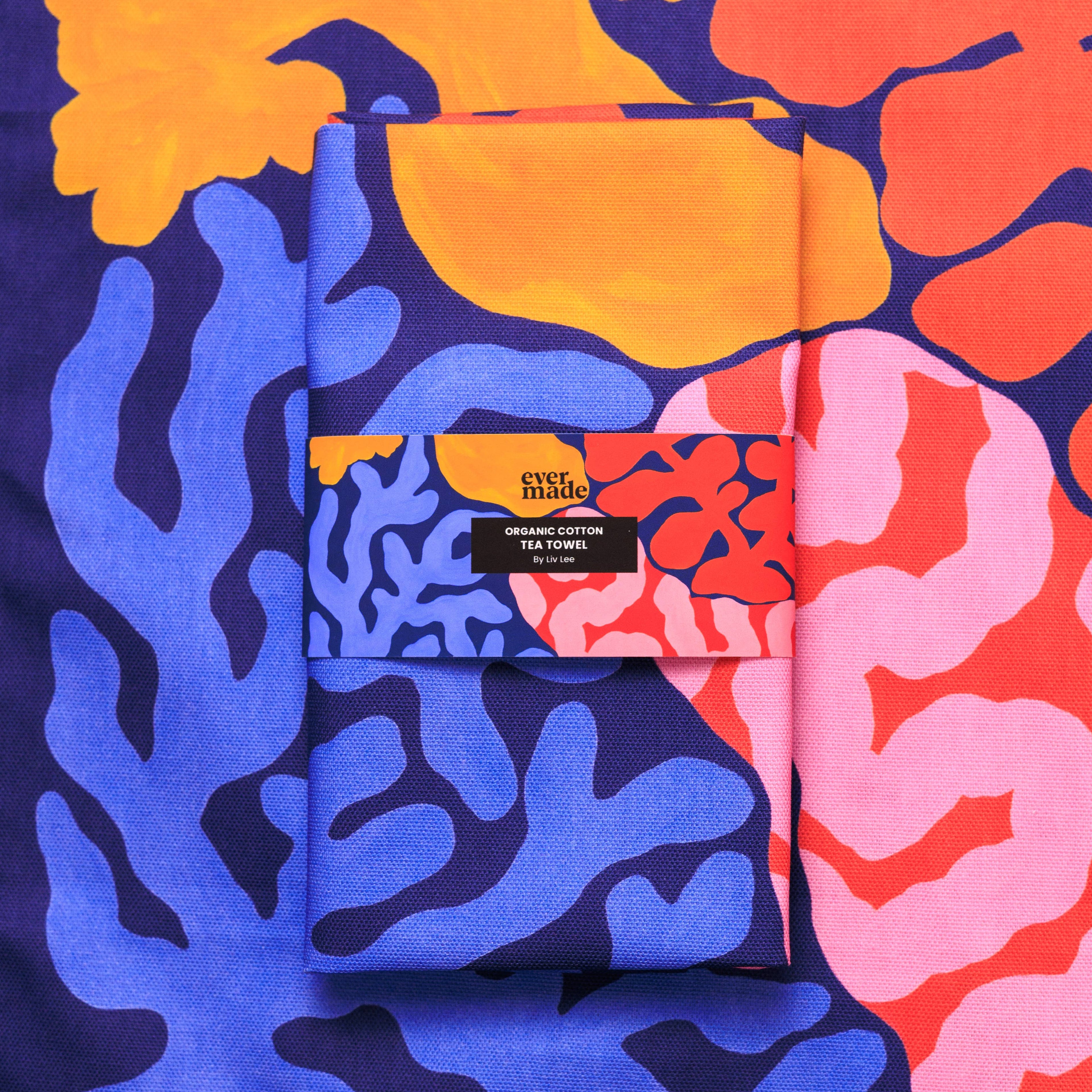Pack of folded towels with colorful abstract patterns and 'ever made' branding.