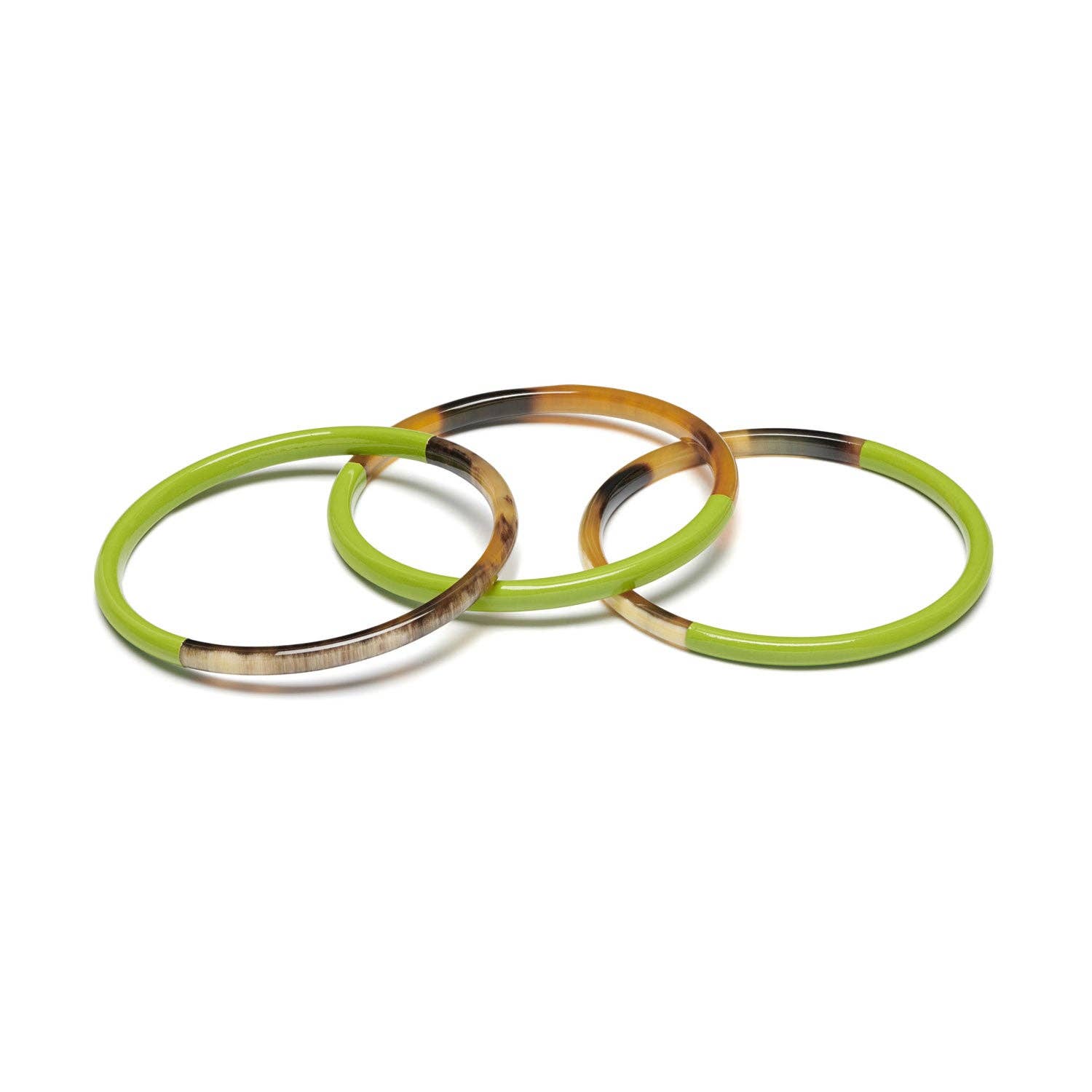 Three green and tortoiseshell bangles on a white background