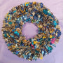 Multicolored fabric wreath on a purple background