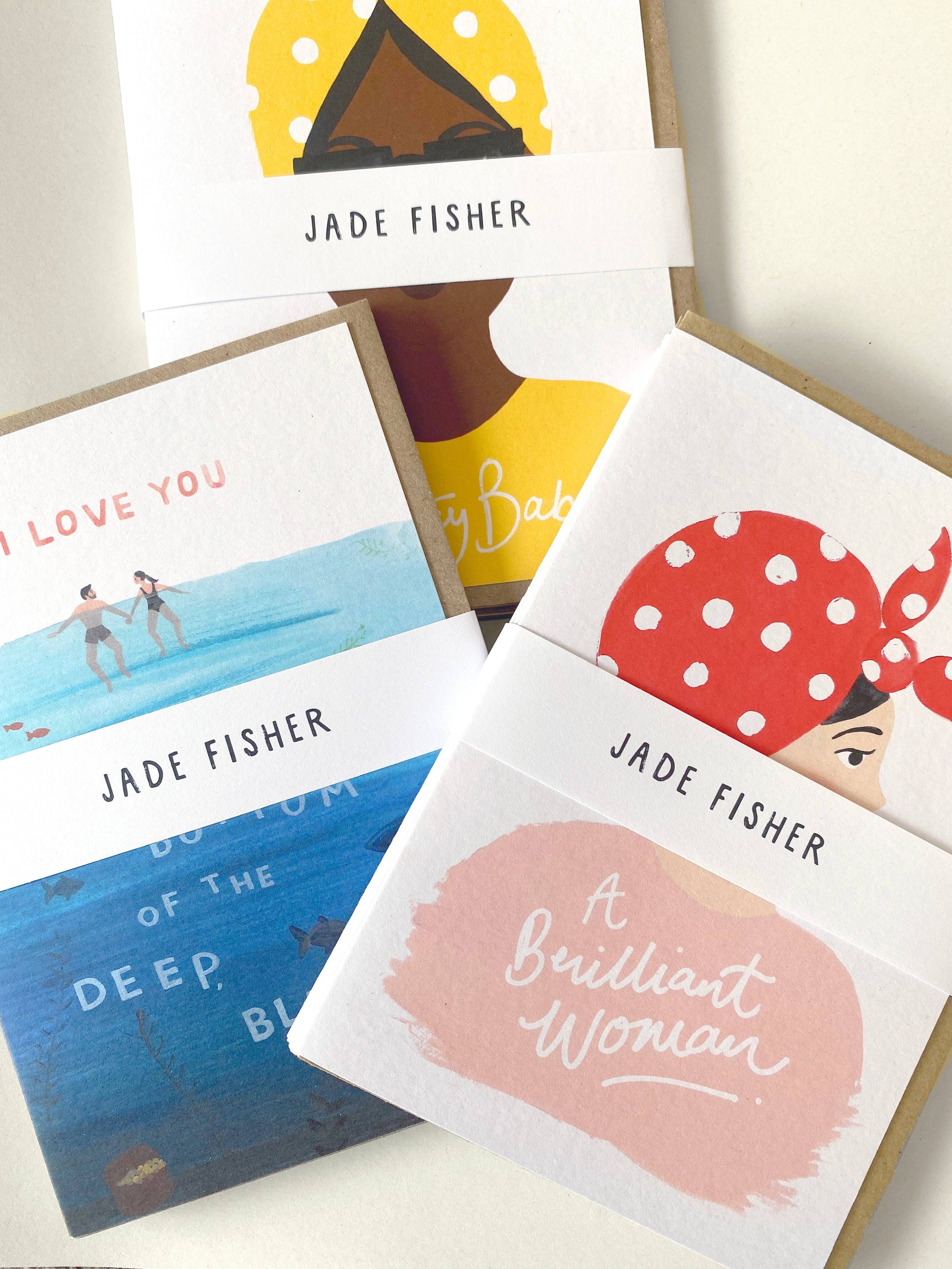 Collection of greeting cards with illustrations and text, featuring the brand 'Jade Fisher'.