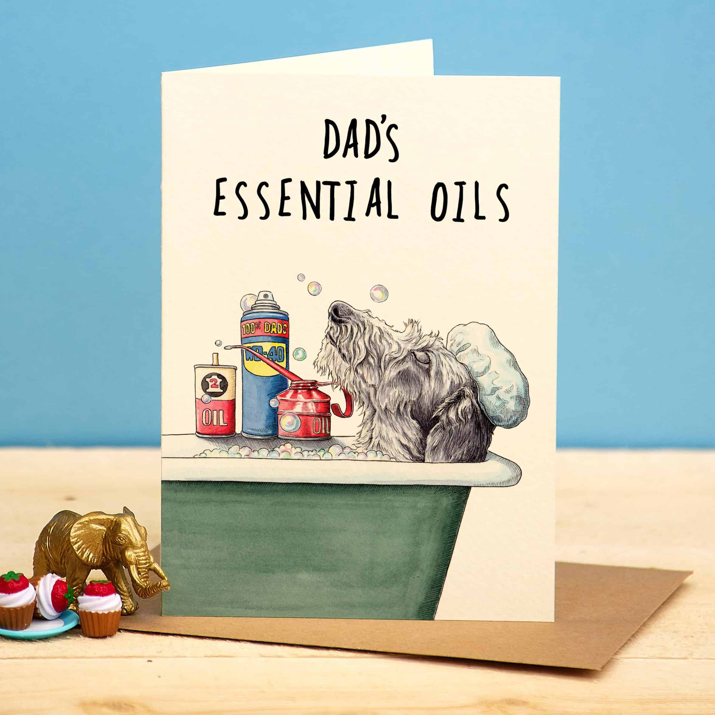 Card with a dog in a bathtub and 'Dad's Essential Oils' text on a blue background