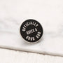 Black and white enamel pin with 'Officially Quite a Good Dad' text on a marble surface.