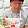 Person holding a box of Arthois Silky Milk Chocolate with colorful packaging