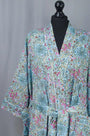 Floral patterned kimono on a mannequin against a gray background