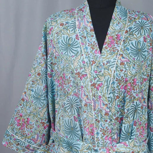 Floral patterned kimono on a mannequin against a gray background