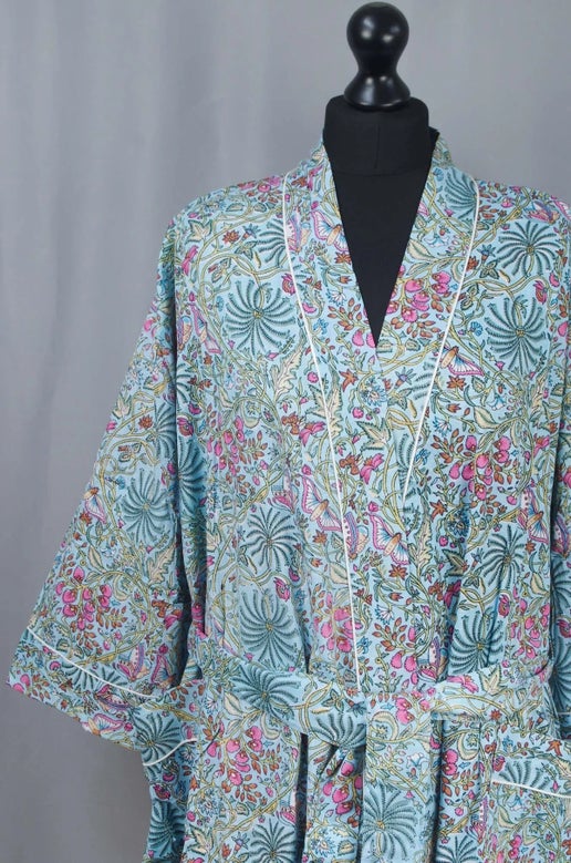 Floral patterned kimono on a mannequin against a gray background